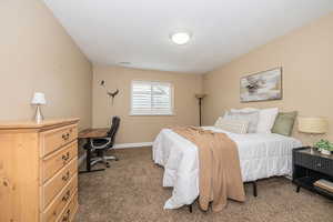 Carpeted bedroom with a textured ceiling