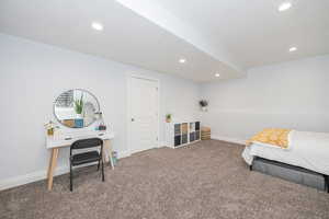 Bedroom featuring carpet and a textured ceiling