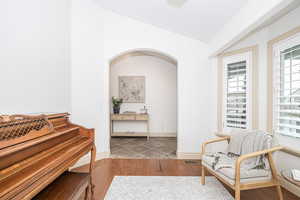 Sitting room with hardwood / wood-style flooring and vaulted ceiling