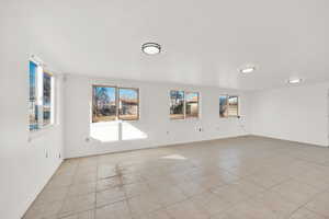 Unfurnished room featuring light tile patterned floors