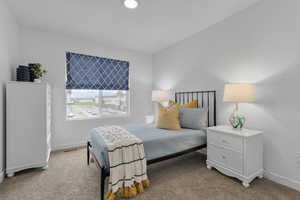 Bedroom featuring light colored carpet