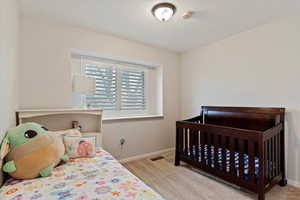 Bedroom featuring light colored carpet