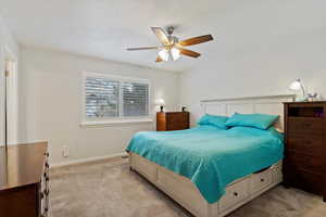 Bedroom featuring ceiling fan and light colored carpet