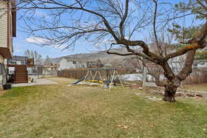 View of yard featuring a playground and a patio