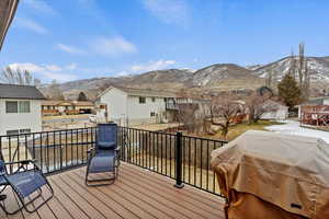 Wooden deck with a grill and a mountain view