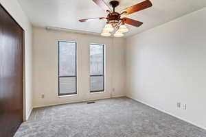 Spare room with carpet flooring, a textured ceiling, and ceiling fan