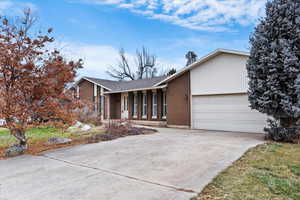 View of front of home with a garage and covered porch