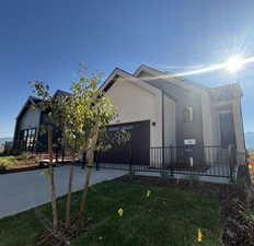 View of front facade featuring a garage and a front yard