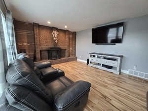 Living room featuring hardwood / wood-style flooring and a fireplace