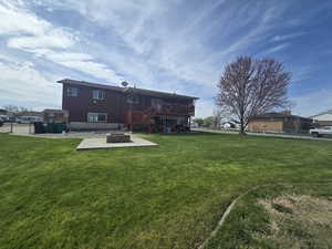 View of yard with an outdoor fire pit, fence, a wooden deck, and stairway