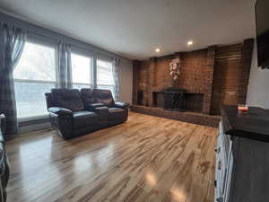 Living room with hardwood / wood-style floors and a fireplace