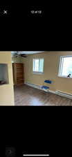 Interior space with a baseboard radiator and light hardwood / wood-style flooring