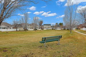 View of property's community with a lawn