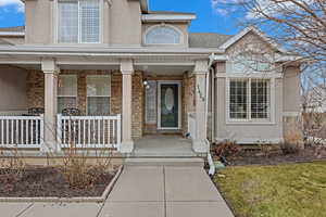 Doorway to property featuring a porch