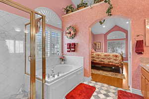 Bathroom with lofted ceiling, vanity, and separate shower and tub