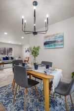 Dining area with hardwood / wood-style flooring and a textured ceiling