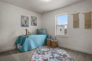 Bedroom featuring carpet floors and a textured ceiling