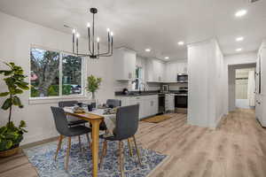 Dining space with sink and light hardwood / wood-style flooring