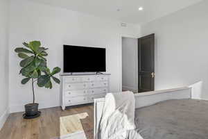 Bedroom with light hardwood / wood-style floors