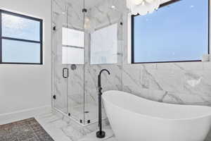 Bathroom featuring separate shower and tub