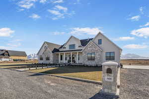 View of front of home featuring a mountain view, a front yard, and covered porch