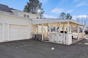 View of parking / parking lot with a garage