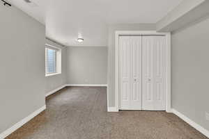 Unfurnished bedroom featuring a closet and carpet