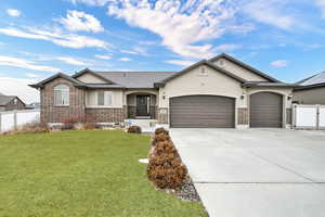 Ranch-style home with a garage and a front yard