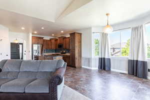 Living room featuring vaulted ceiling and sink