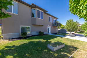 Exterior space featuring a balcony and a yard