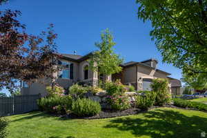 View of front of property featuring a garage and a front yard