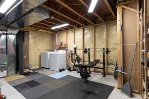 Basement with washer and clothes dryer and heating unit