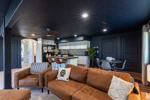 Living room featuring wood-type flooring and ceiling fan