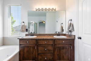 Bathroom with vanity and plus walk in shower