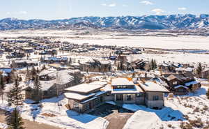 Snowy aerial view featuring a mountain view