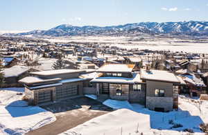 Snowy aerial view featuring a mountain view