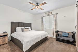 Carpeted bedroom with ceiling fan