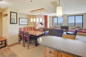 Dining area featuring a mountain view and a tray ceiling