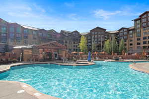 View of pool with hot tubs