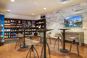 Bar with hardwood / wood-style floors