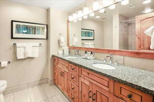 Bathroom with vanity, tile patterned floors, and toilet