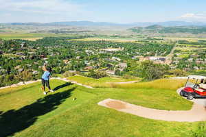 Aerial view featuring a mountain view and golf course