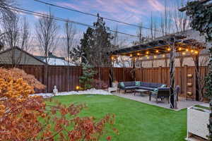 Yard at dusk with a pergola, outdoor lounge area, and a patio