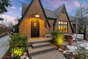 Tudor-style house featuring an outdoor living space and a patio area