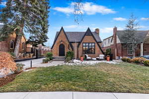 Tudor-style house featuring outdoor lounge area and a front yard