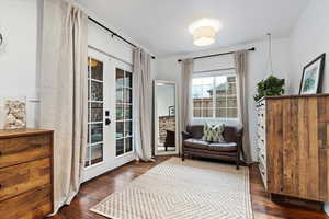 Living area featuring dark hardwood / wood-style flooring and french doors