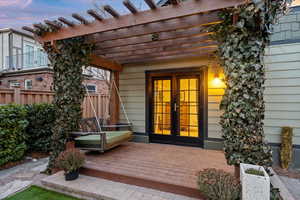 Exterior space with a pergola, french doors, and a deck