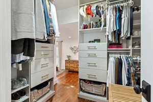 Walk in closet featuring hardwood / wood-style flooring