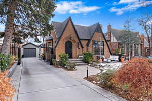 Tudor-style house featuring an outbuilding and a garage