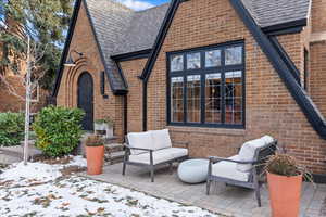 Snow covered property featuring an outdoor living space and a patio area